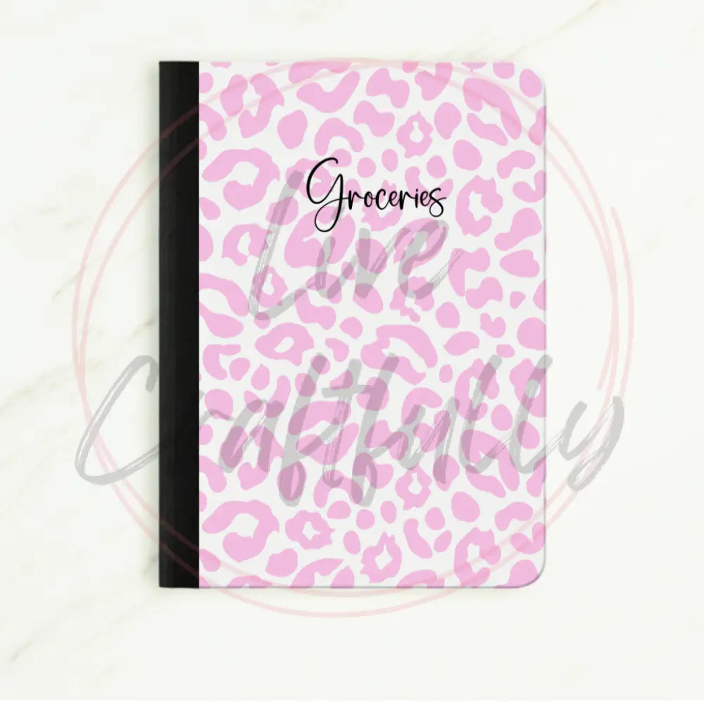 Notebook with pink leopard print with "groceries" in cursive in the middle