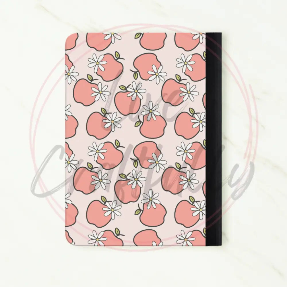 Notebook with pink apple pattern on a white background