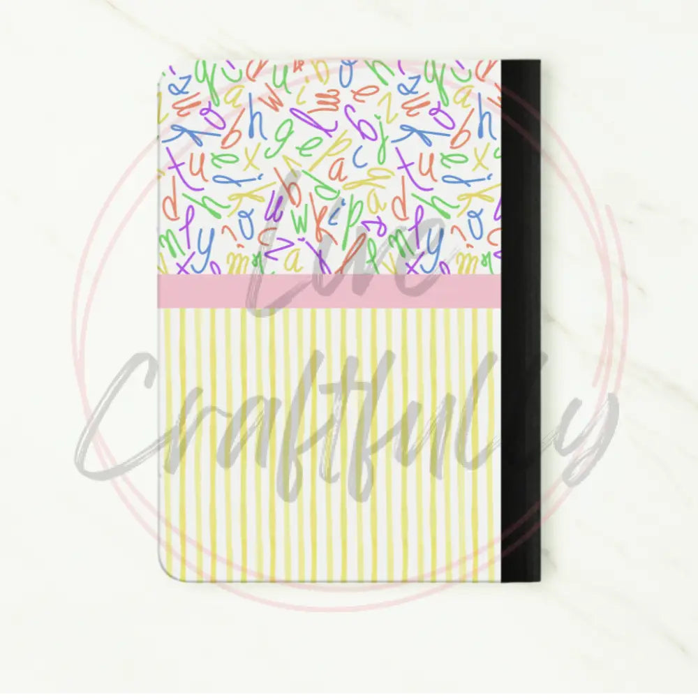 Notebook with colorful patterned cover on a white background