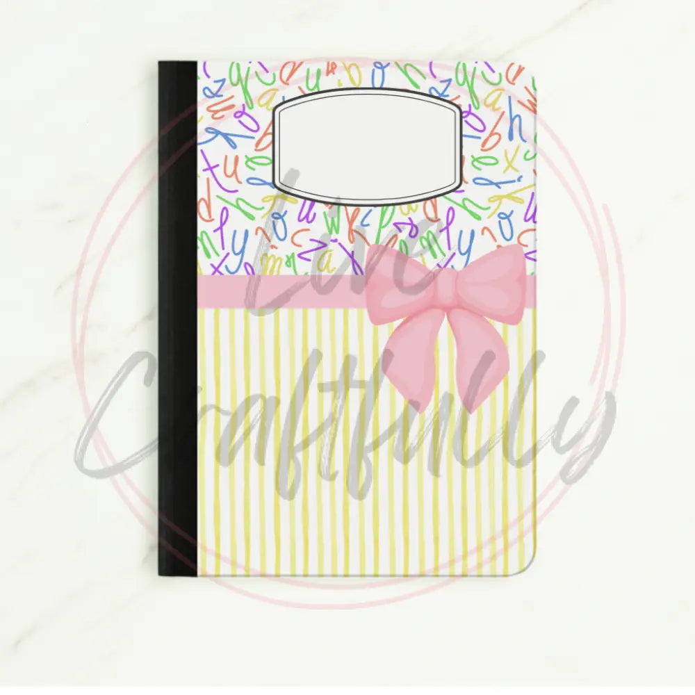 Notebook with colorful lettering and a pink bow on a white background