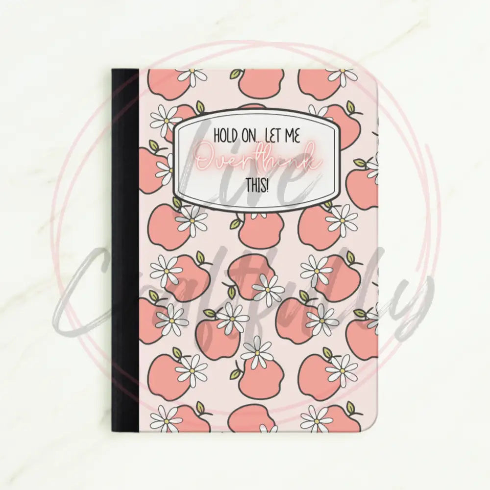 Notebook with pink apple pattern and text on a white background