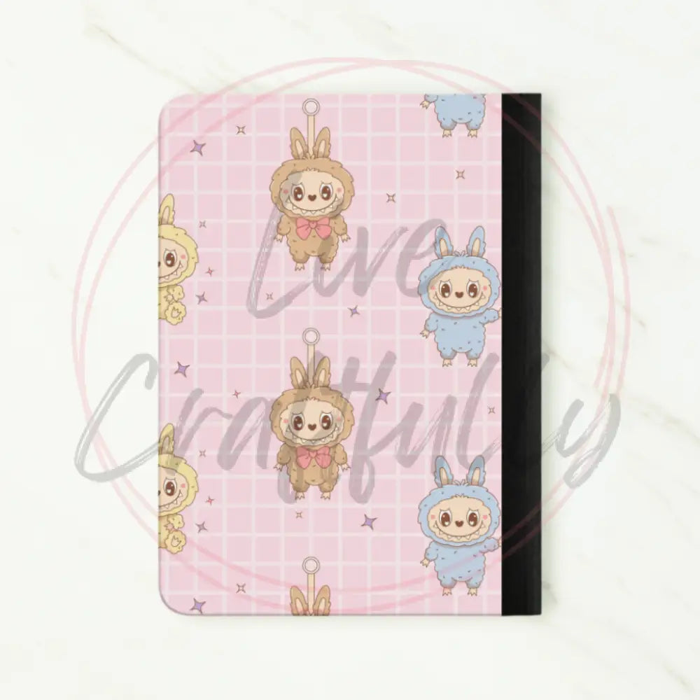 Notebook with cartoon character design on a pink grid background