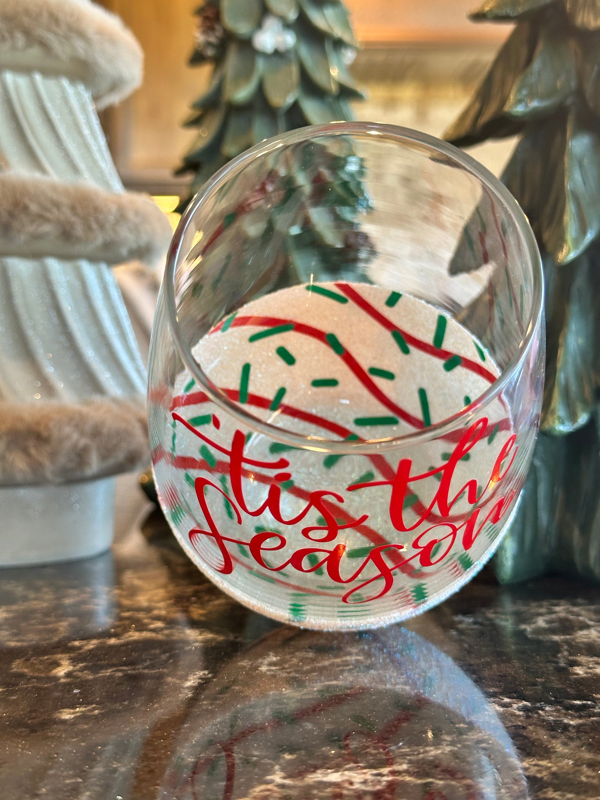 Decorative glass plates with festive designs on a wooden surface.