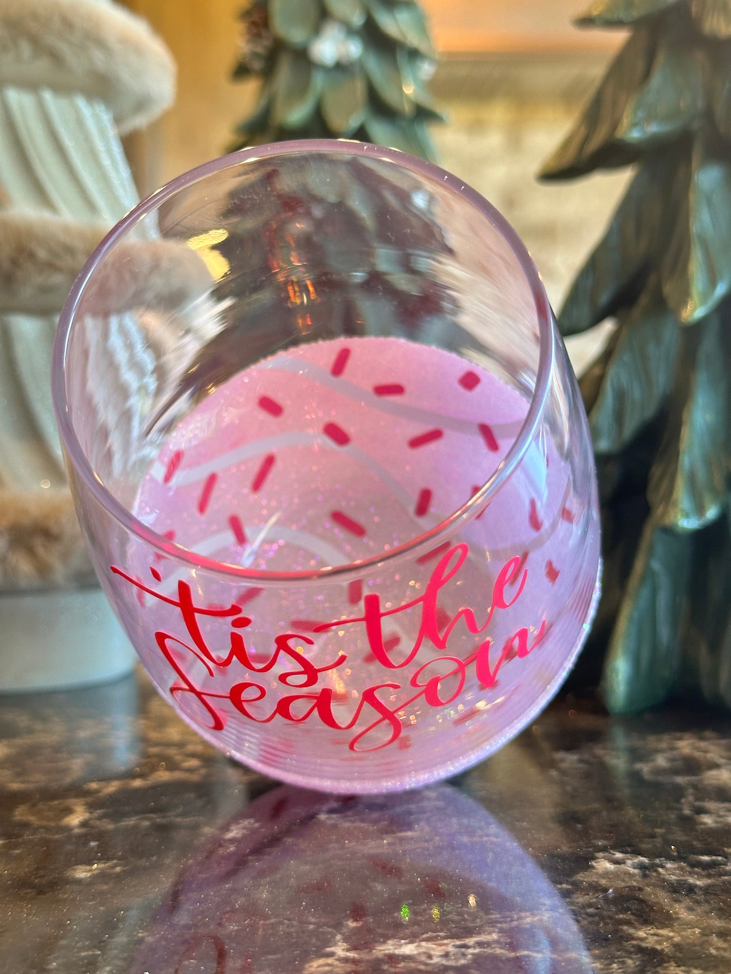 Decorative pink ornament with red text on a blurred background