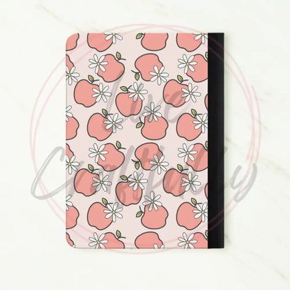 Notebook with pink apple pattern on a white background