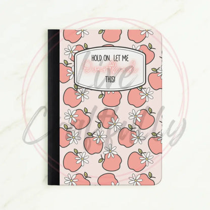 Notebook with pink apple pattern and text on a white background